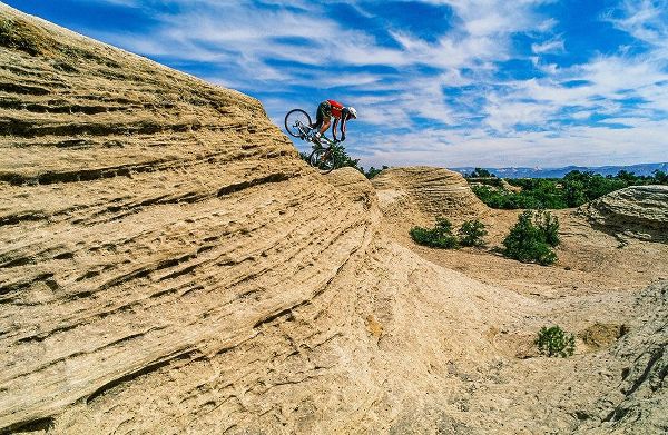 Mountain biker balances courage and danger and attempting to avoid crash on Red Rock-Utah-USA (MR)